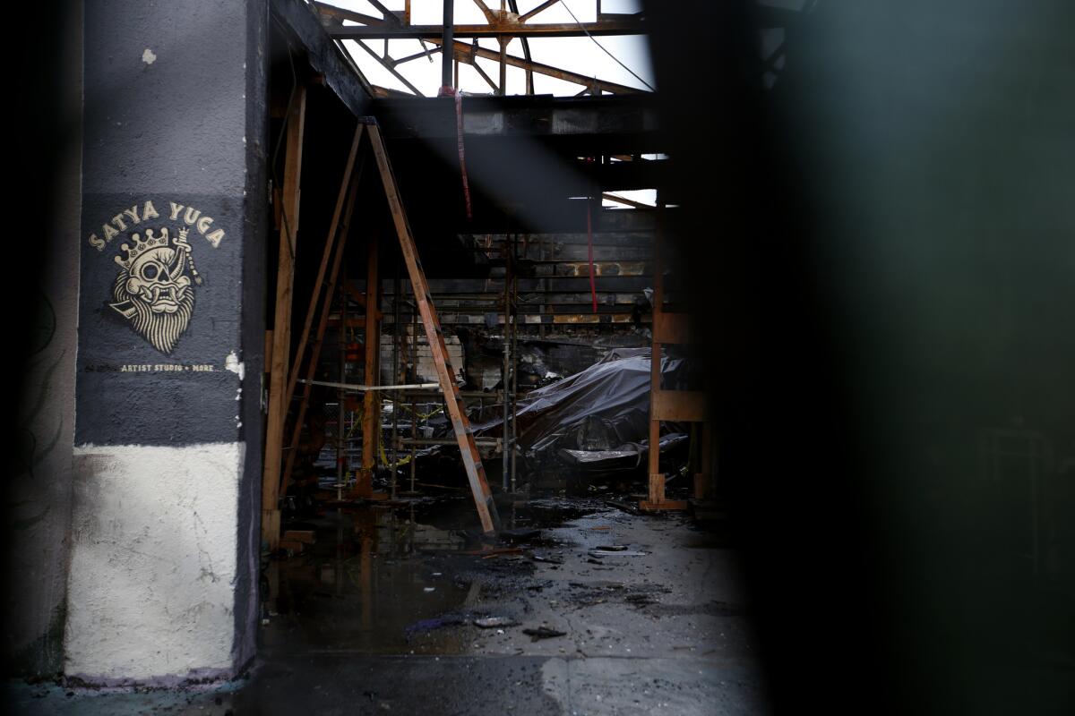 A view through the fence around the Ghost Ship warehouse following the December 2016 fire 