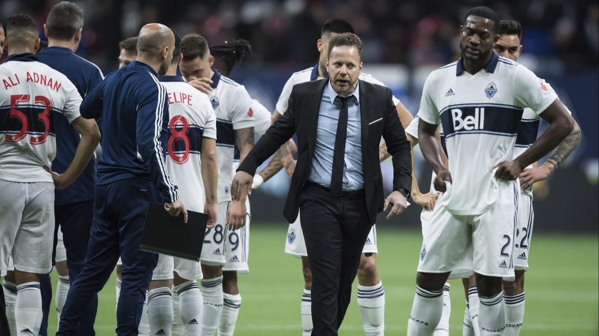 Vancouver Whitecaps coach Marc Dos Santos, second from right, walks off the field after the first half of a 1-0 loss to the Los Angeles Galaxy on April 5.