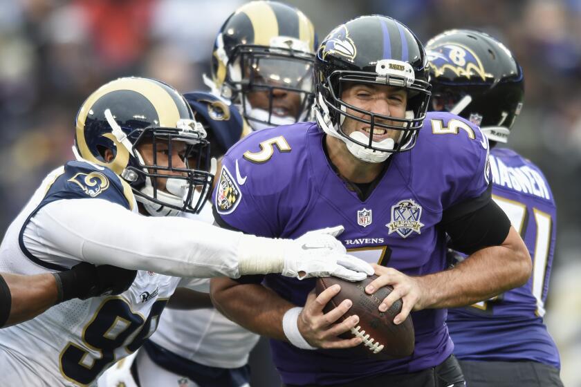 FILE - In this Nov. 22, 2015, file photo, Baltimore Ravens quarterback Joe Flacco (5) is sacked by St. Louis Rams defensive tackle Aaron Donald (99) during the first half of an NFL football game in Baltimore. Arizona Cardinals quarterback Carson Palmer said the Rams’ defense, with the likes of Donald, Alec Ogletree and Robert Quinn, ``is as good as it gets.’’ (AP Photo/Gail Burton, File)