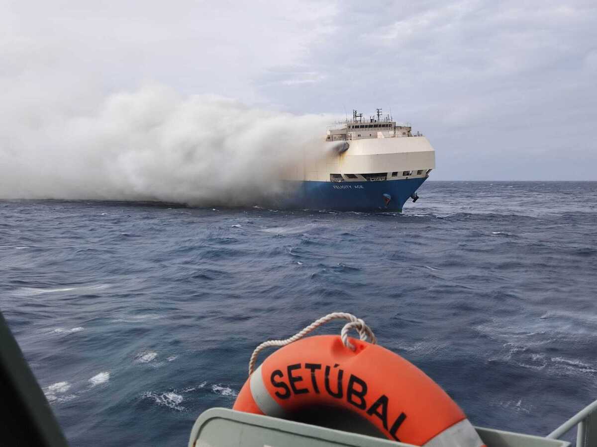 Smoke billows from a burning car transport ship, as seen from the Portuguese Navy NPR Setubal ship.