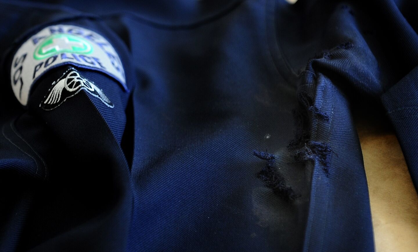 A uniform with bullet holes that belonged to an officer who was shot in the lobby of a station on Venice Boulevard.