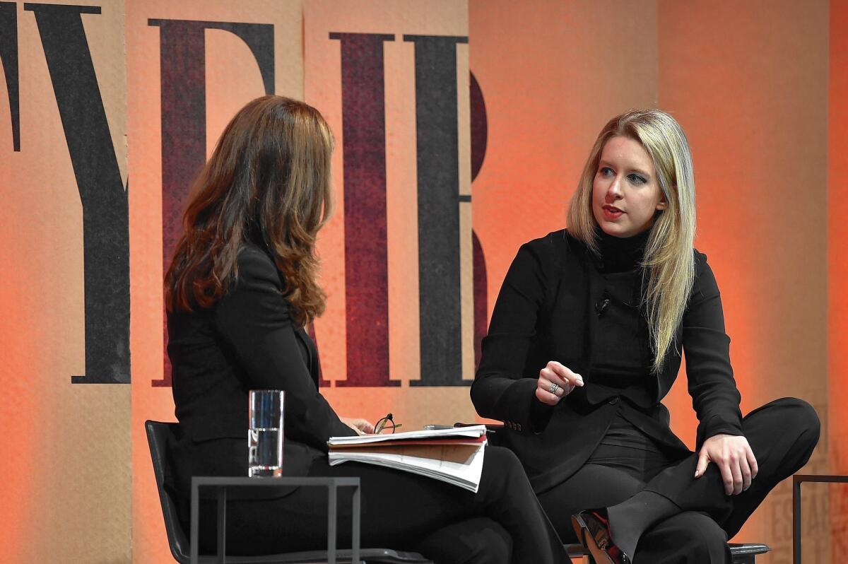 Elizabeth Holmes, right, founder and chief executive of blood-testing firm Theranos Inc., with NBC News’ Maria Shriver at a Vanity Fair event in October.