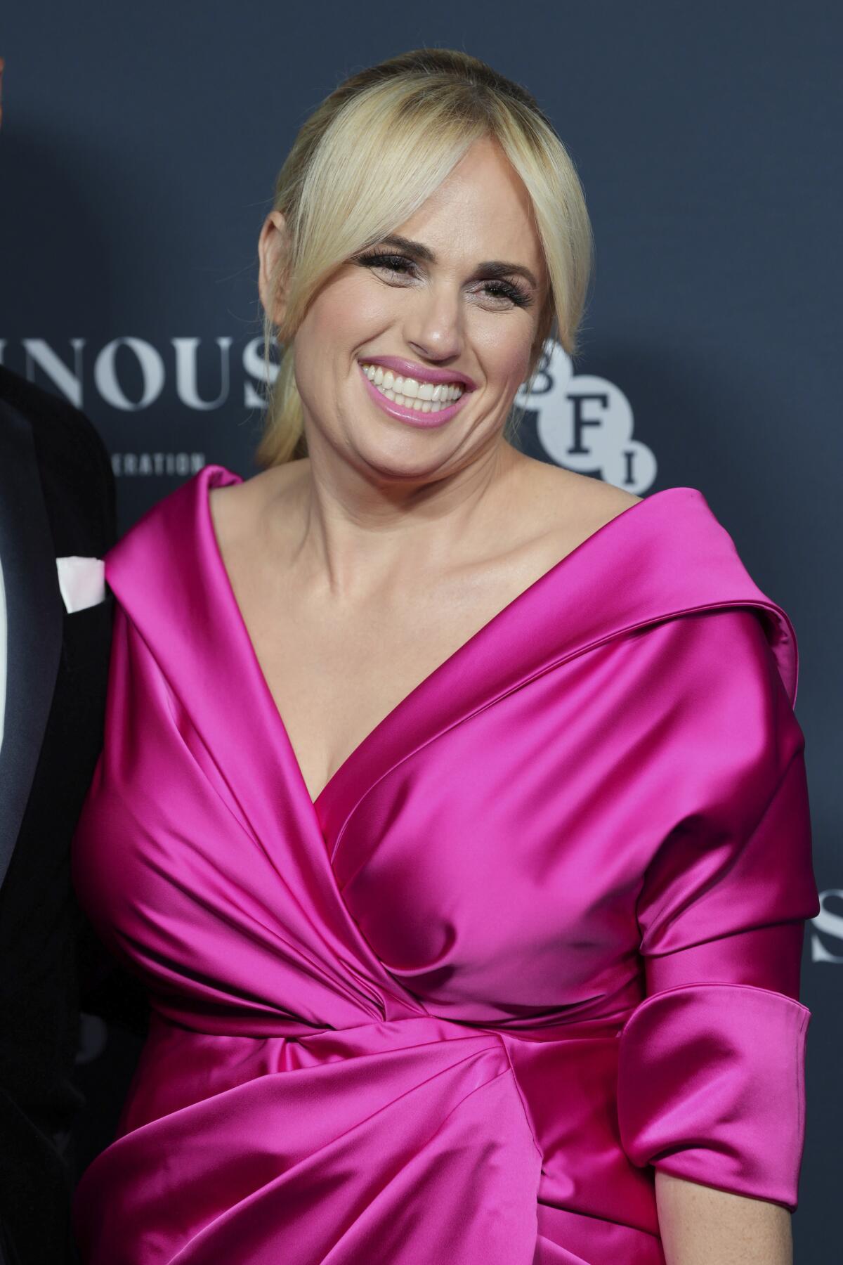 rebel wilson purple dress Rebel Wilson prepares for a 'hot girl summer' after 60-pound weight loss as star shows off her figure in a workout top