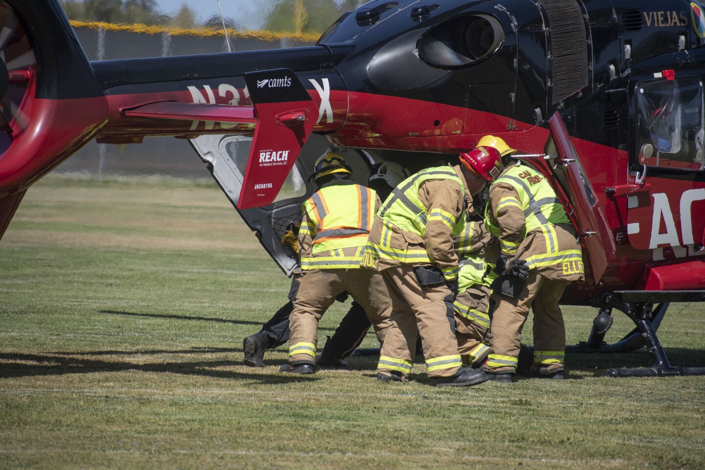 Cal Fire works to put mock accident victim Travis Kerr in the helicopter.