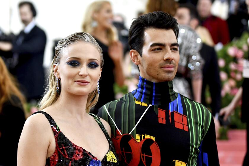 Sophie Turner and Joe Jonas wearing matching colorful outfits at the Met Gala