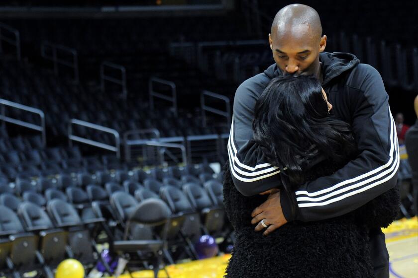 Kobe Bryant kisses his wife Vanessa after his last game at Staples Center on April 13, 2016.