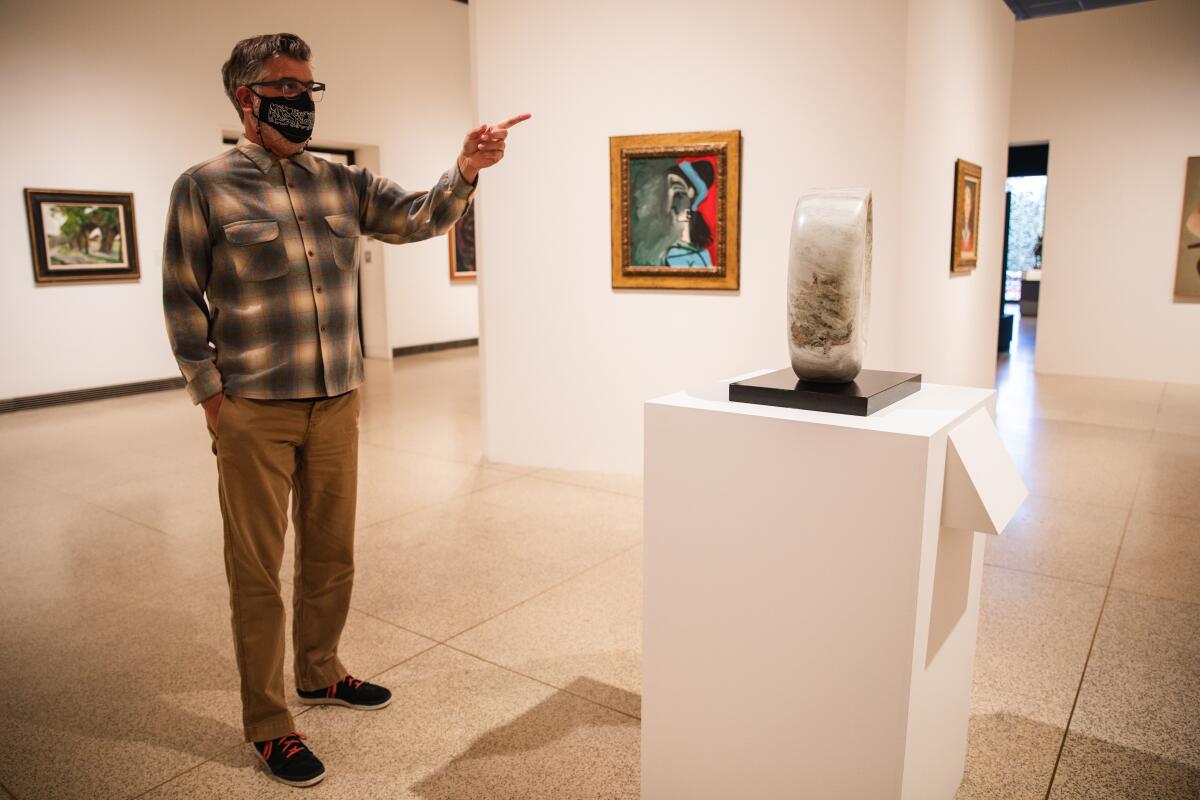 Chacho Herman points out artwork at The San Diego Museum of Art on Wednesday, March 17.  