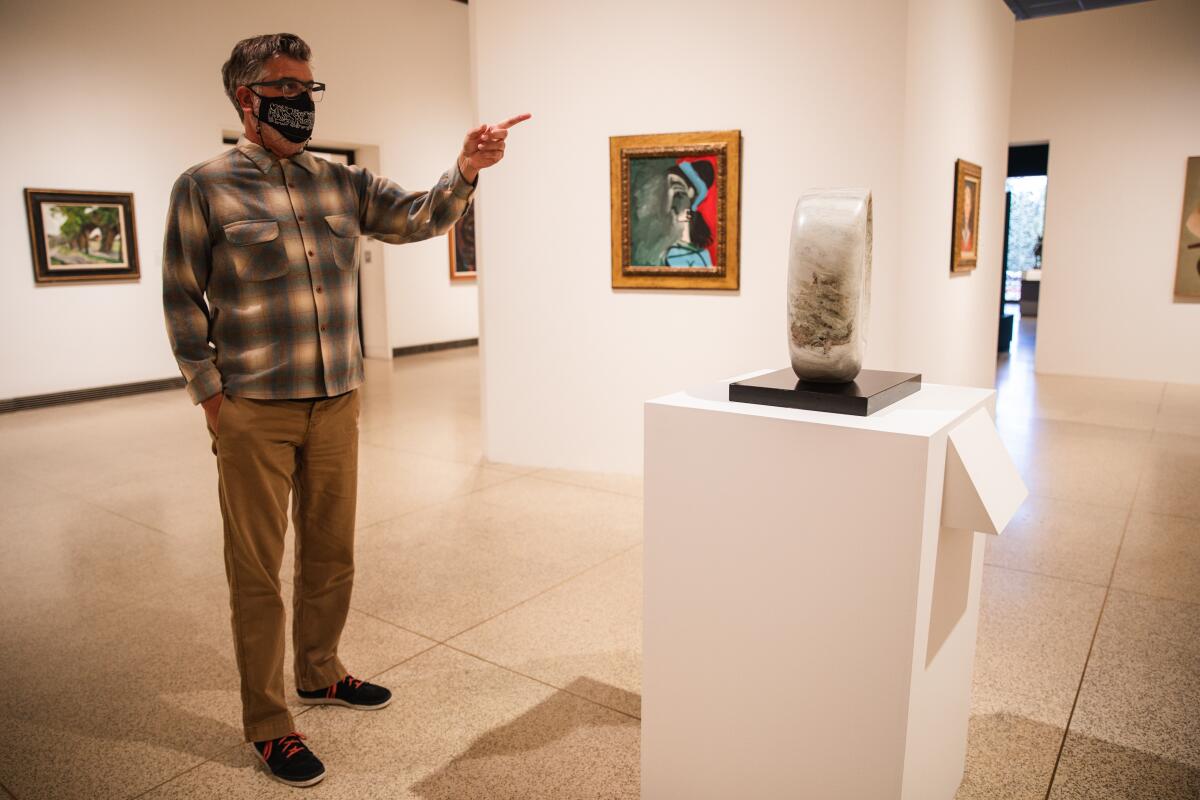 Chacho Herman points out artwork at The San Diego Museum of Art on Wednesday, March 17.