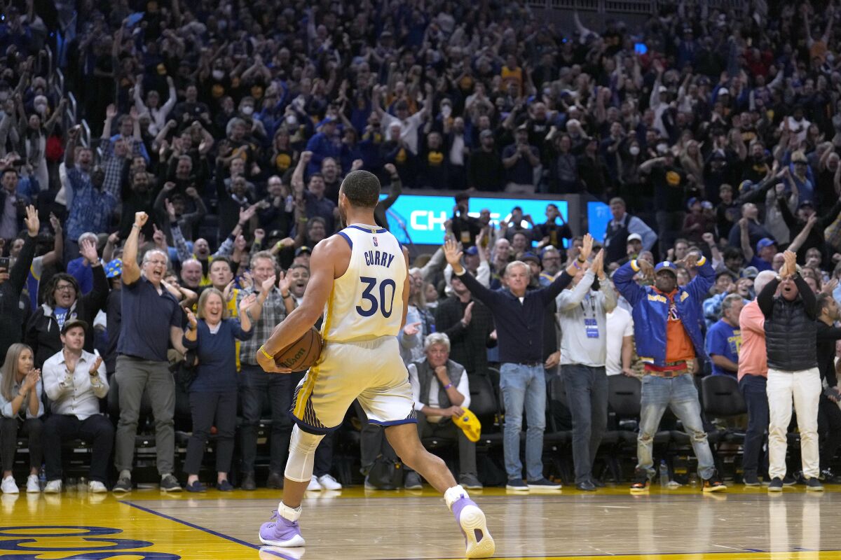 Golden State Warriors guard Stephen Curry (30) celebrates with the crowd in the final minute against the Memphis Grizzlies during the second half of Game 4 of an NBA basketball Western Conference playoff semifinal in San Francisco, Monday, May 9, 2022. The Warriors won 101-98. (AP Photo/Tony Avelar)