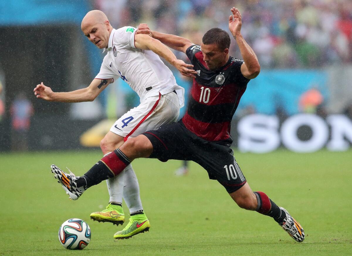 Michael Bradley, left, battling Germany's Lukas Podolski during during a World Cup group game, says of the MLS that "after almost 20 years we can all agree that to take this league where everyone wants to take it, changes need to be made."