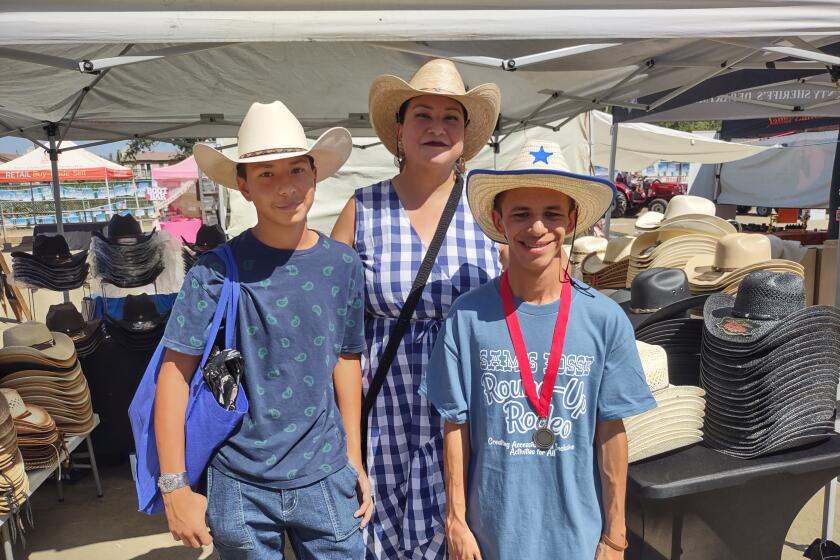 Poway resident Andrea Valadez, center, brought her two sons to the rodeo, Elias Osuna, left, and Octavio Osuna.