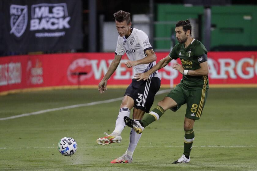 Philadelphia Union defender Jack Elliott, left, and Portland Timbers midfielder Diego Valeri move the the ball during the second half of an MLS soccer match, Wednesday, Aug. 5, 2020, in Kissimmee, Fla. (AP Photo/John Raoux)
