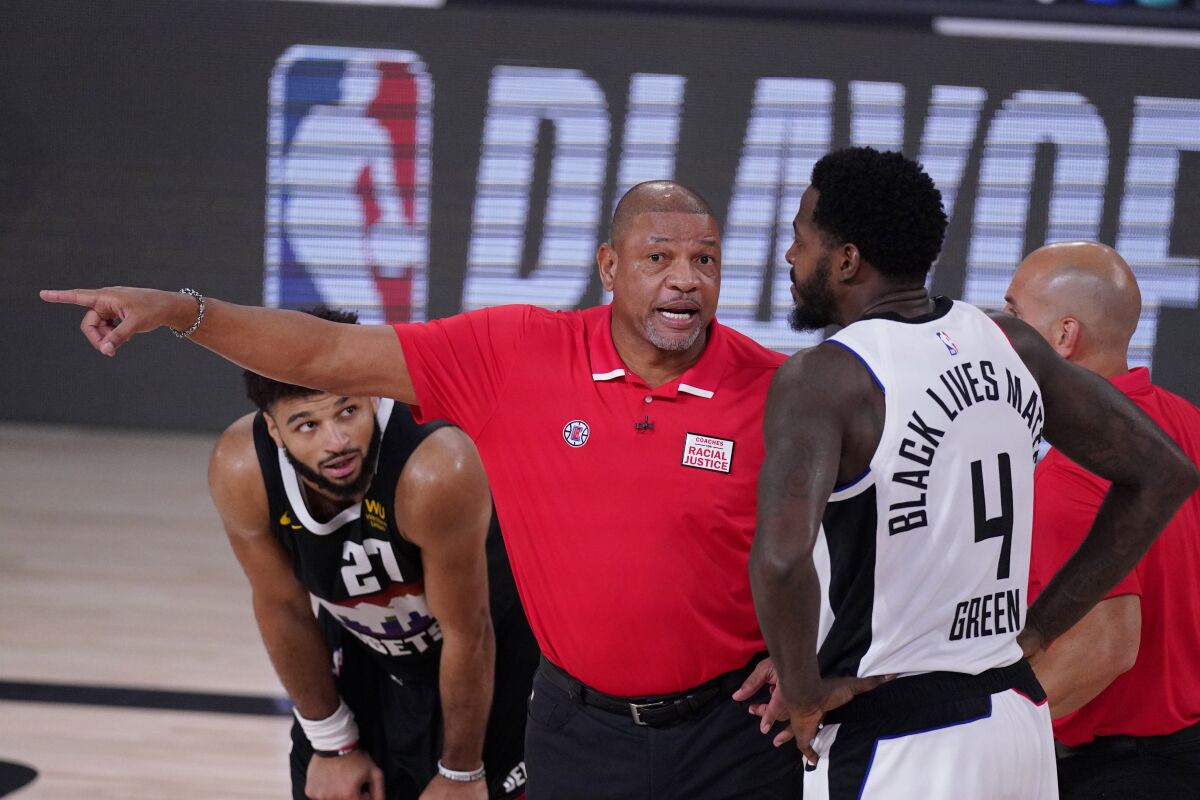Doc Rivers talks to Clippers forward JaMychal Green during a playoff game against the Nuggets on Sept. 13, 2020.