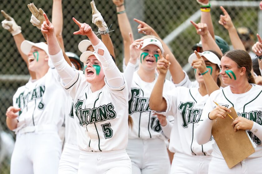 Poway, CA - May 23: Poway's Hailey Milgazo (5), center, and teammates celebrate Sophia Burmeister's (15) home run against Carlsbad during the fourth round of the CIF-San Diego Section Open Division playoffs at Poway High School on Tuesday, May 23, 2023 in Poway, CA. (Meg McLaughlin / The San Diego Union-Tribune)