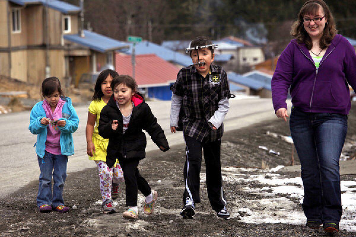 James Weatherwax, 11, second from right, and other children run alongside teacher Johanna Lambeth before attending Bible study class at the Salvation Army Church in Klawock, Alaska. James was to travel to Seattle the following day to have his halo removed at Children's Hospital.