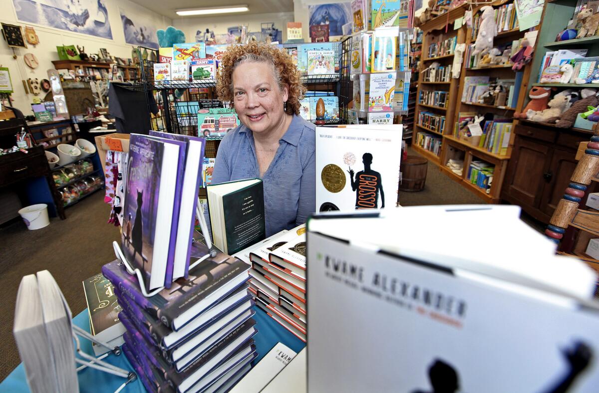 Once Upon A Time Books owner Maureen Palacios poses for a photo on Monday. The bookstore is getting an award from state Sen. Carol Liu next month.