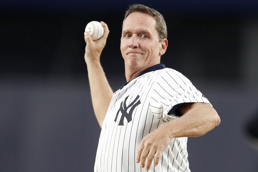 FILE - Former New York Yankees pitcher David Cone throws out a ceremonial first pitch for the second game of a baseball doubleheader between the Yankees and the Tampa Bay Rays, Thursday, July 18, 2019, in New York. Former players David Cone and Eduardo Perez are joining Karl Ravech to form a new broadcast team for ESPN's “Sunday Night Baseball” telecasts. (AP Photo/Kathy Willens, File)