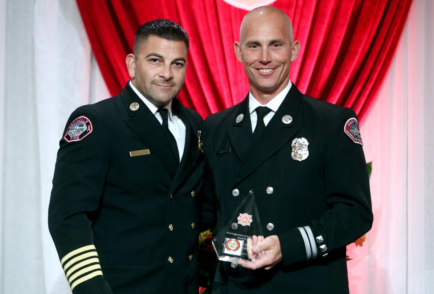 Glendale Fire Department chief Silvio Lanzas, left, awarded the Distinguished Service Award to GFD fire captain paramedic Derek Tamburro, at the City of Glendale Fire Department 2019 Awards Luncheon, at the Hilton in Glendale, on Wednesday, Oct. 16, 2019. The event was sponsored by the City of Glendale, the Glendale Fire Dept., the Glendale Fire Foundation and the Glendale Sunrise Rotary.