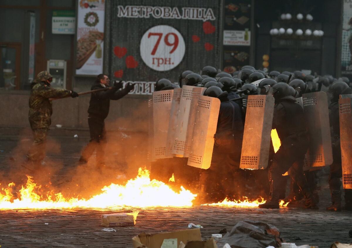 Protesters clash with police in central Kiev, Ukraine, on Thursday morning.
