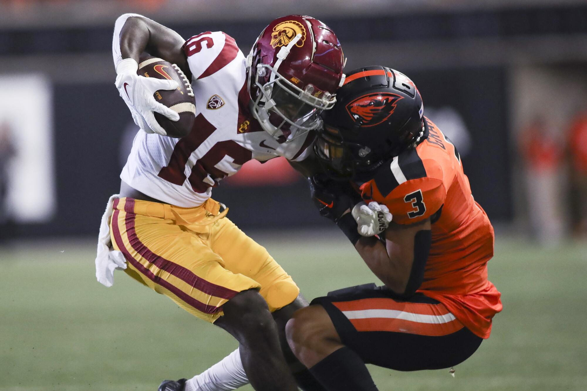 USC wide receiver Tahj Washington is brought down by Oregon State defensive back Jaydon Grant.