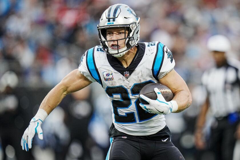 Carolina Panthers running back Christian McCaffrey carries the ball against the San Francisco 49ers on Oct. 9, 2022.