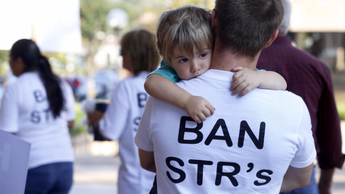 Opponents of short-term rentals protest outside an Anaheim City Council meeting in June.