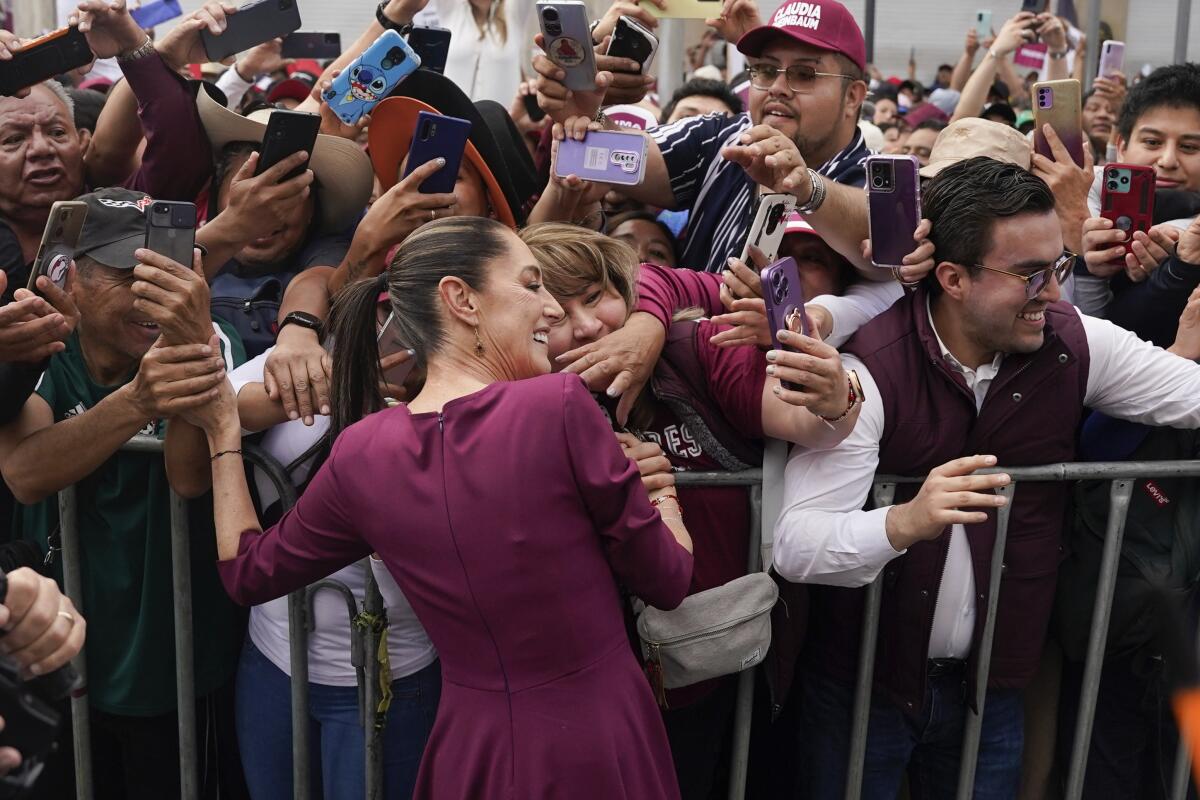 Presidential candidate Claudia Sheinbaum greets supporters upon her arrival to her opening campaign rally at the Zocalo in Mexico City, Friday, March 1, 2024. General Elections are set for June 2. (AP Photo/Aurea de Rosario)