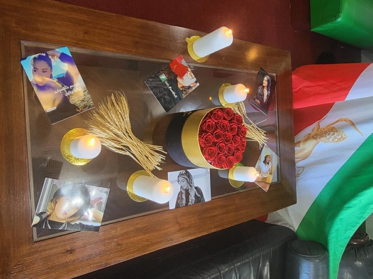 A table with photos, roses and candles on it
