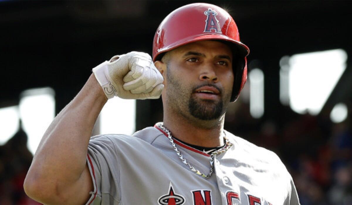 Albert Pujols celebrates after one of his two home runs during the Angels' 8-4 victory over the Rangers on Saturday.