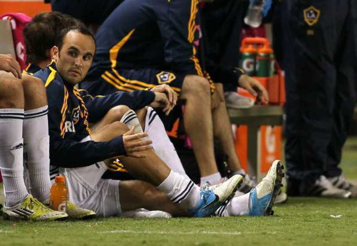 Landon Donovan of the Galaxy sits on the sidelines after injuring his leg during last Saturday's game against Real Salt Lake.
