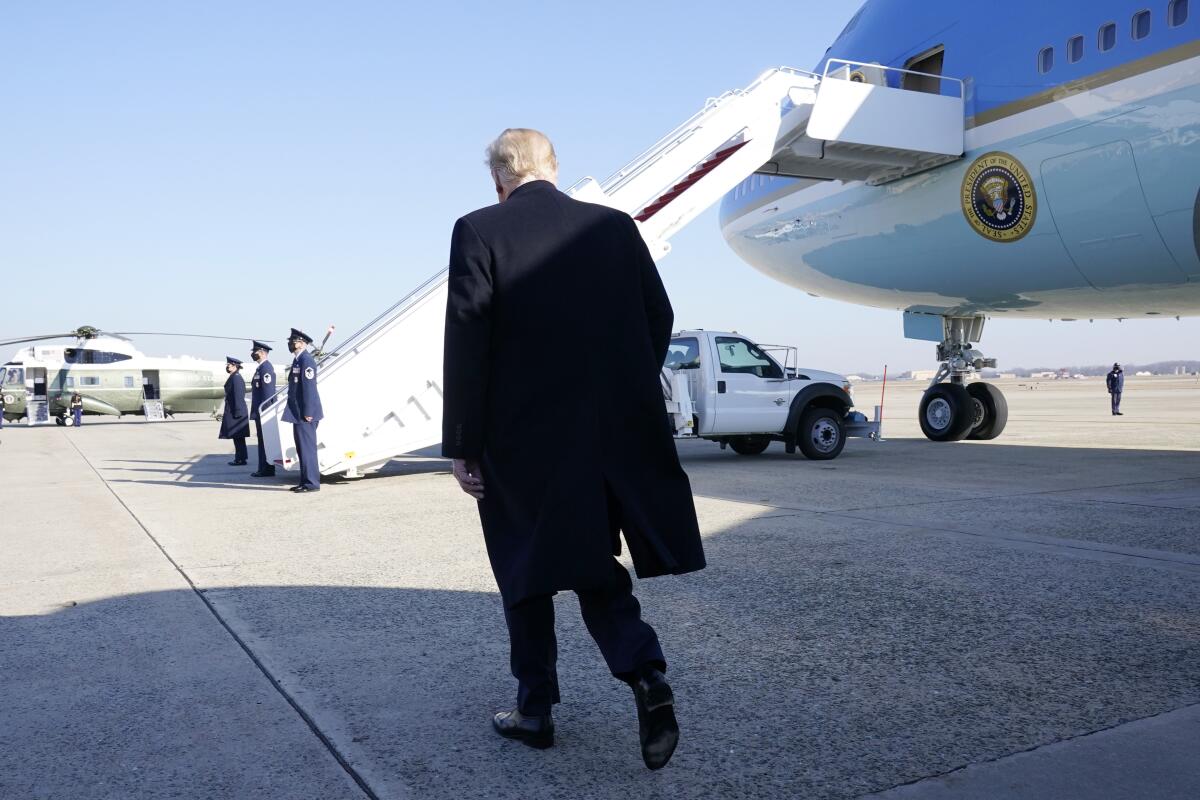 President Trump walks to board Air Force One.