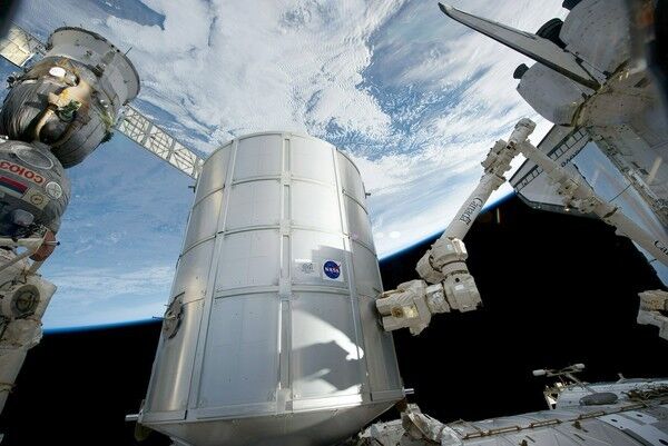 STS-133 space shuttle Discovery at the International Space Station -- PMM