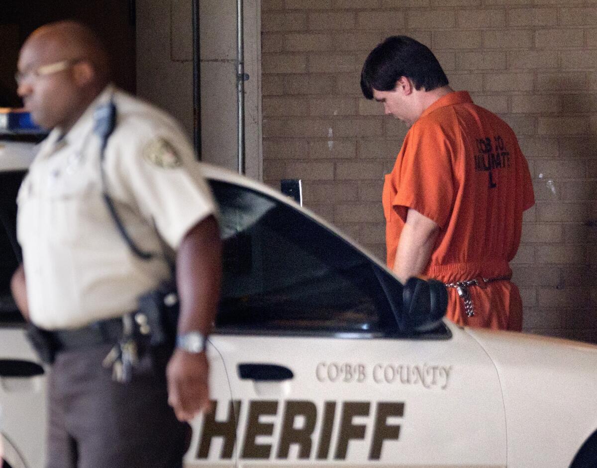 Justin Ross Harris, right, the father of a toddler who died after he was left in a hot car, arrives for a court hearing July 3 in Marietta, Ga.