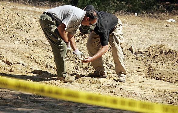 Mammoth Lakes Sgt. Paul Dostie, left, and forensic anthropologist Dan Larson from Cal State Long Beach join several dozen local, state and federal authorities and other forensic scientists in the search for the remains of 16-year-old Roger Dale Madison.