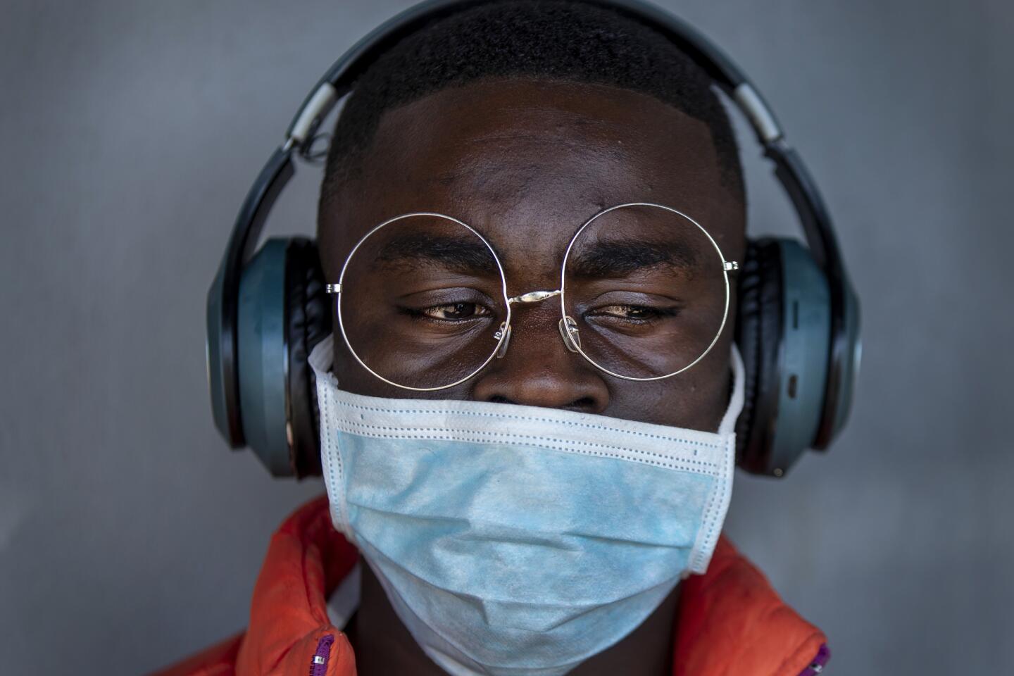 South Africa: A barber wears a surgical mask at a hair salon in Soweto, South Africa.