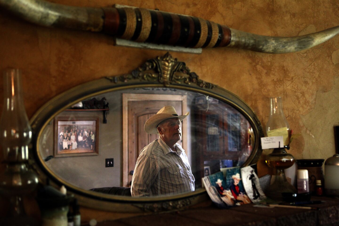 Rancher Cliven D. Bundy, 67, is reflected in a mirror that rests on a mantle place in his home in Bunkerville, Nevada.