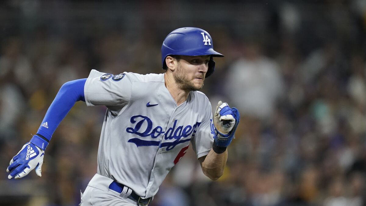 Trea Turner of the Dodgers hits a hot single in the seventh inning in Game 4 against the Padres.