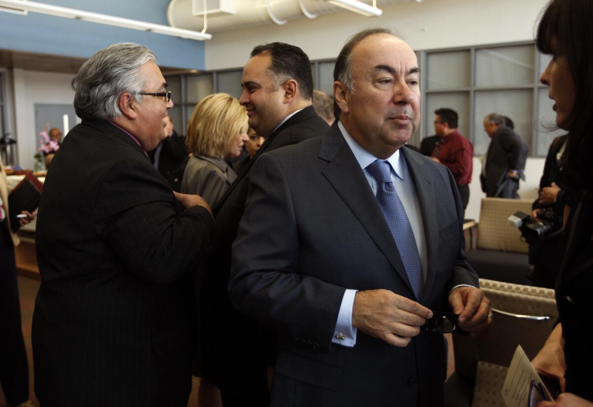 State Sen. Ron Calderon, left, talks with California Assembly Speaker John Perez, while former Assemblyman Tom Calderon, center, talks with a friend at a memorial service for his wife, Marcella, in Montebello.