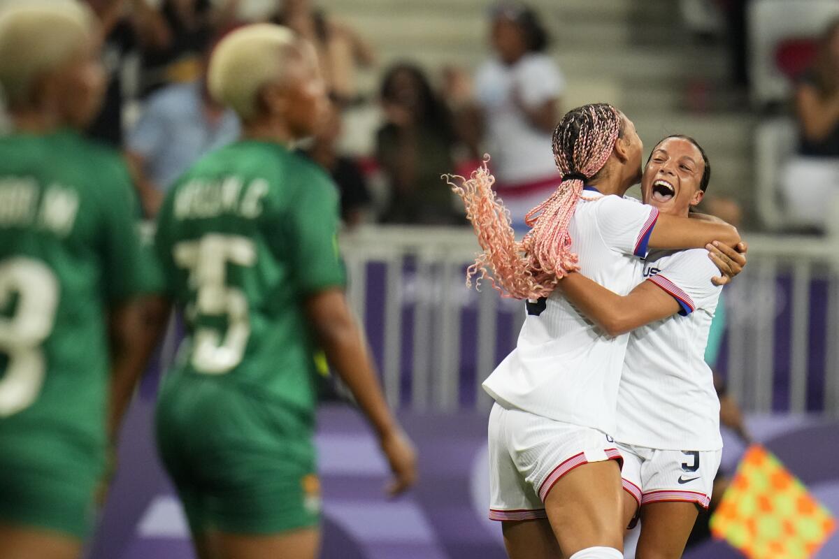 American Trinity Rodman jumps into teammate Mallory Swanson's arms after scoring 