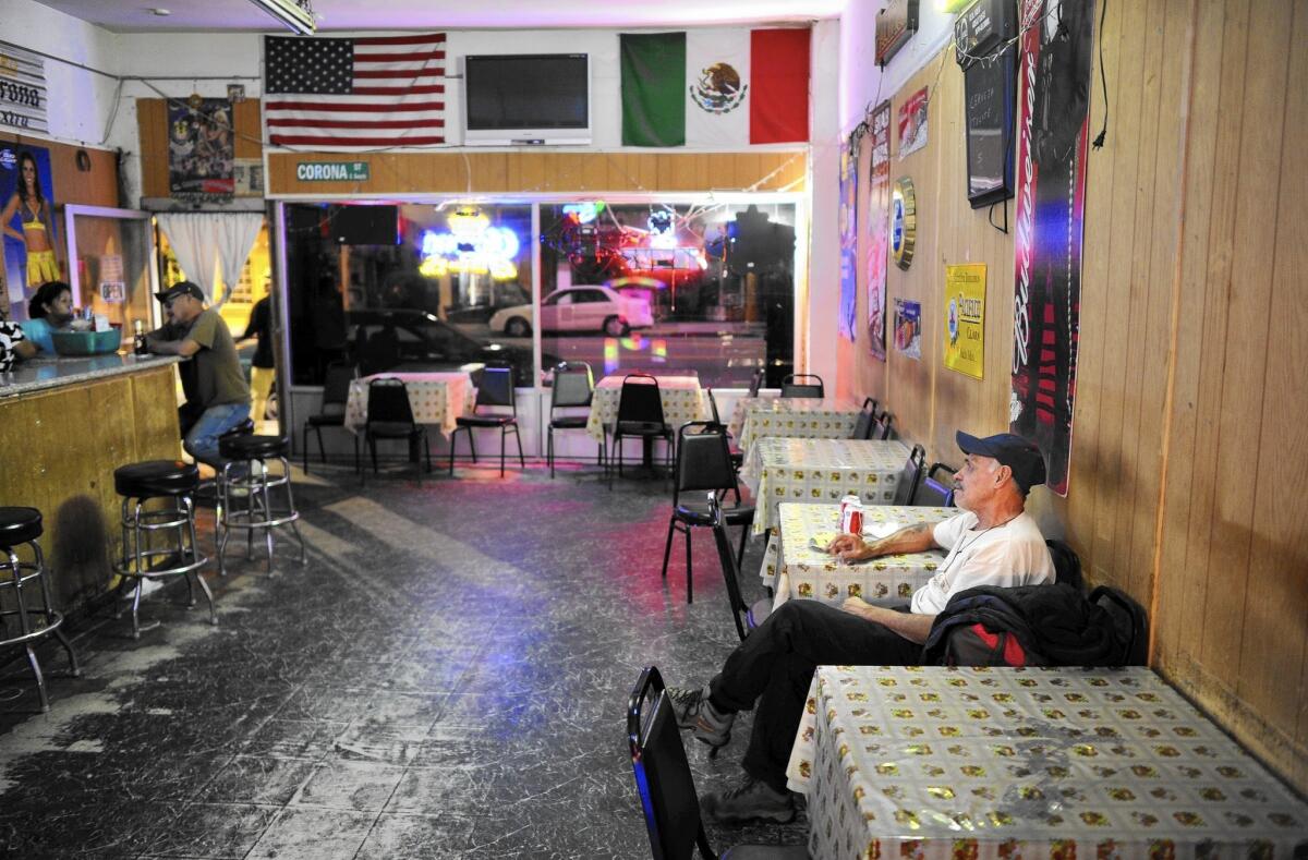 The closure of the Las Palomas bar in Boyle Heights reflects the gentrification in the Eastside neighborhood. Above, customers at the bar in March 2015.