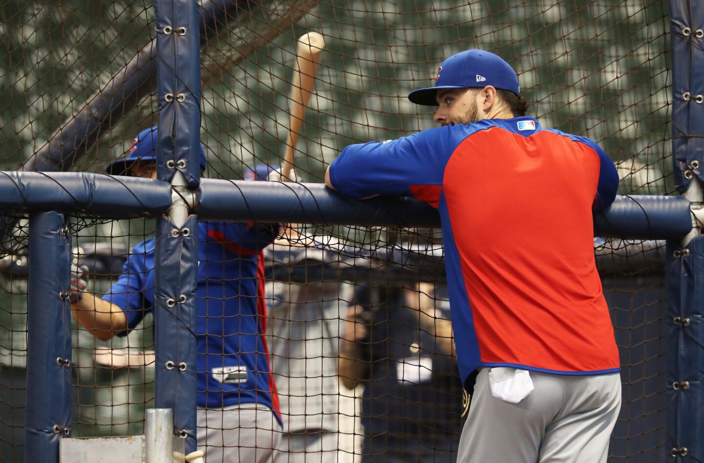Cubs third baseman Kris Bryant watches teammate Willson Contreras take batting practice before a game against the Brewers at Miller Park on Sept. 5, 2018.