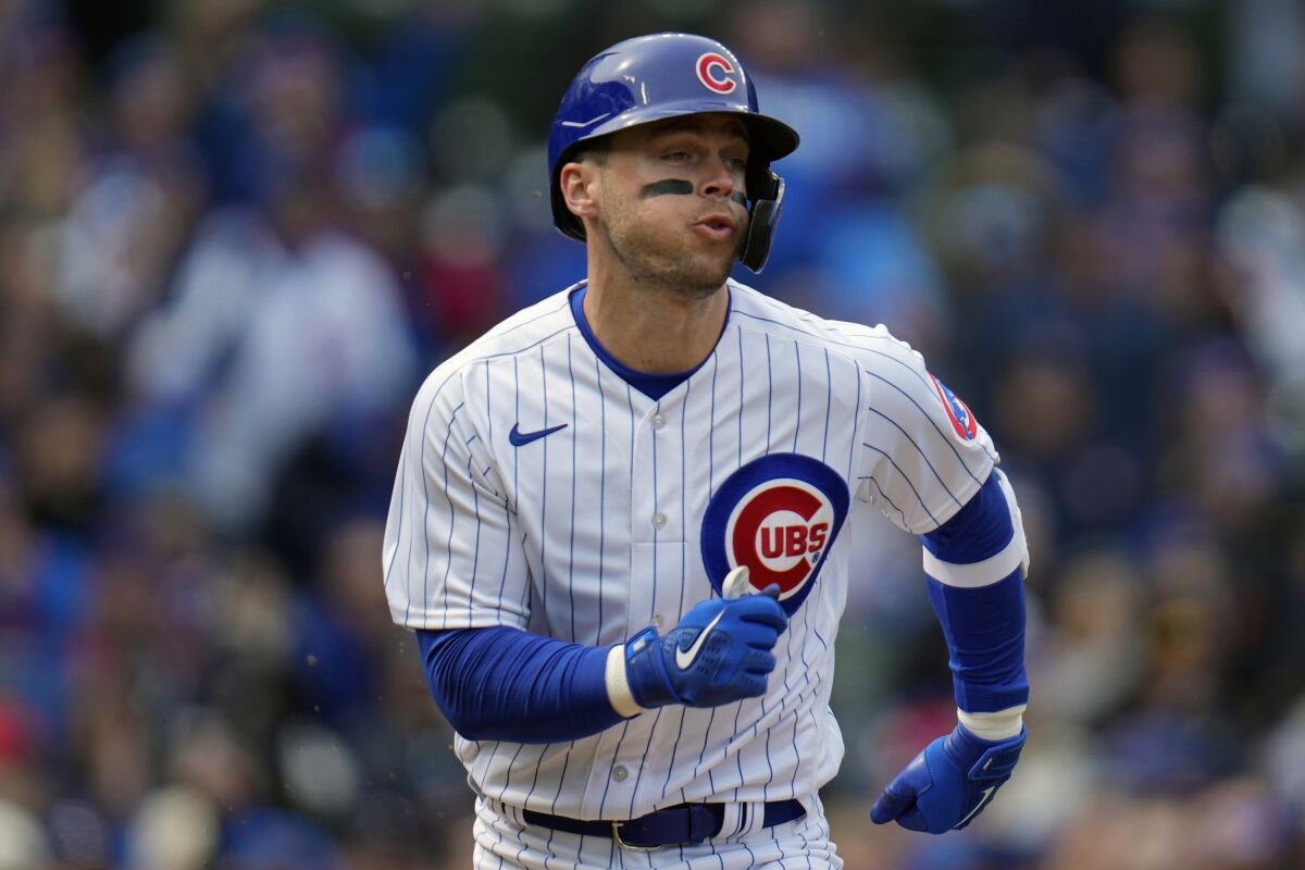 Chicago Cubs second baseman Nico Hoerner hits a single during the third inning of a baseball game against the Milwaukee Brewers Thursday, March 30, 2023, in Chicago. (AP Photo/Erin Hooley)
