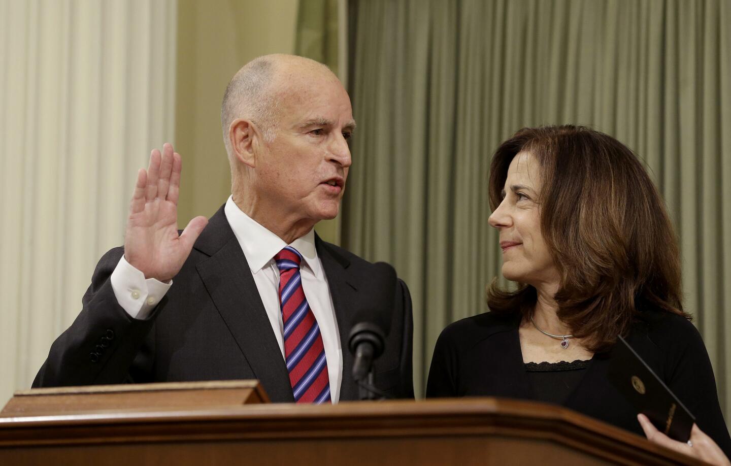 California Gov. Jerry Brown takes the oath of office for his fourth term as governor as his wife, Anne Gust Brown, looks in January 2015.