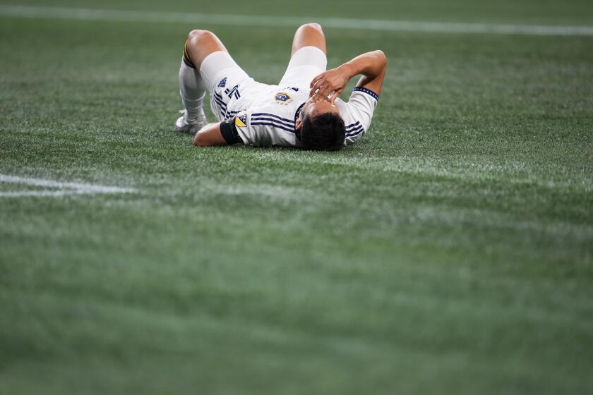 LA Galaxy defender Maya Yoshida (4) lies on the ground during the second half of an MLS soccer match against the Seattle Sounders, Wednesday, Oct. 4, 2023, in Seattle. The Sounders won 2-1. (AP Photo/Lindsey Wasson)