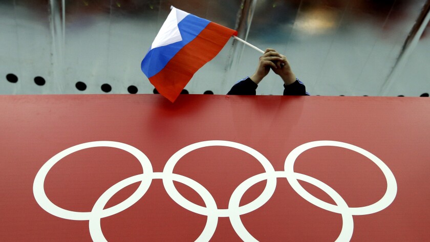 A Russian fan at waves a flag during the Sochi Winter Games.