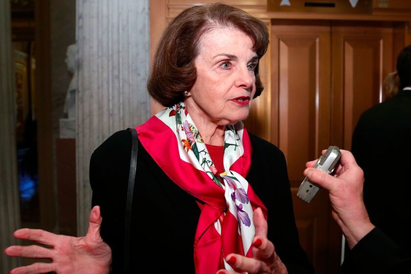 FILE--In this Dec. 19, 2017, file photo, Sen. Dianne Feinstein, D-Calif., speaks with a reporter on Capitol Hill in Washington. Feinstein says she won't vote for a stopgap spending measure to keep the U.S. government open if it doesn't include protections for young immigrants. (AP Photo/Alex Brandon, file)