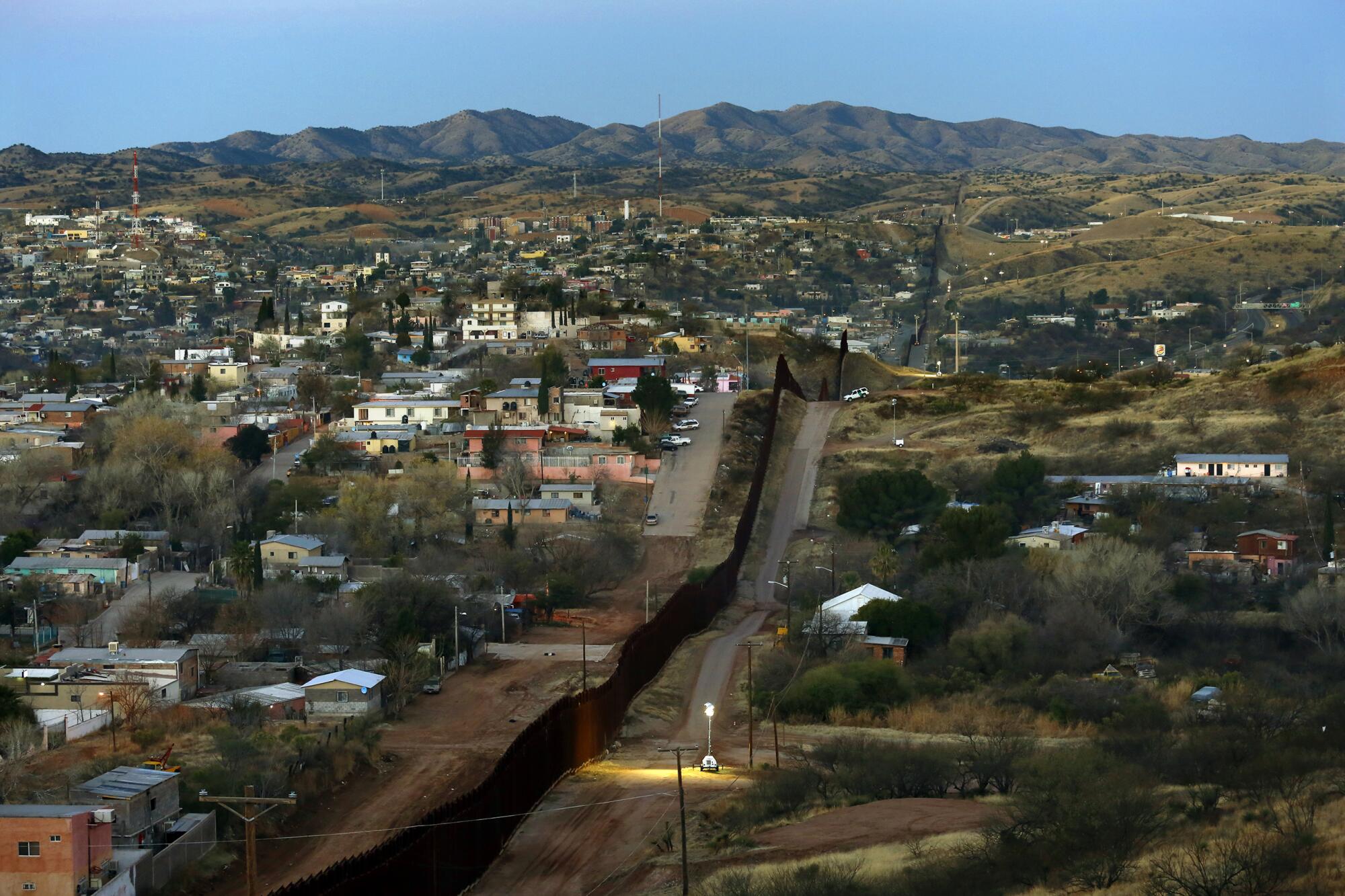 The border fence snakes along the U.S.-Mexico line east of Nogales, Ariz. 