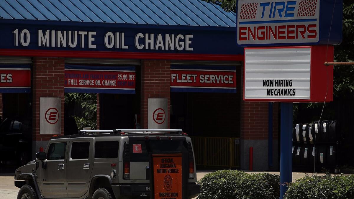 A "now hiring" sign is posted in front of an oil-changing business in Baton Rouge, La., on May 5.