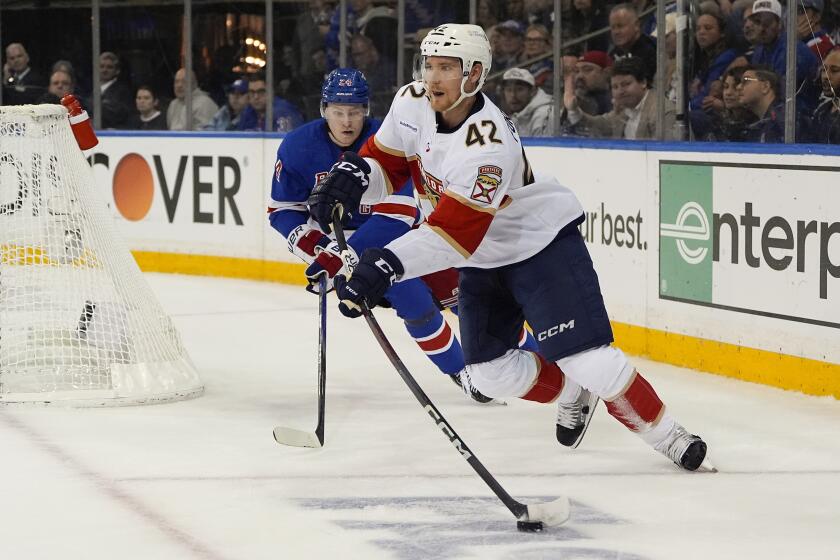 Florida Panthers defenseman Gustav Forsling (42) looks to pass the puck against New York Rangers right wing Kaapo Kakko (24) during the second period of Game 1 of the NHL hockey Eastern Conference Stanley Cup playoff finals, Wednesday, May 22, 2024, in New York. (AP Photo/Julia Nikhinson)