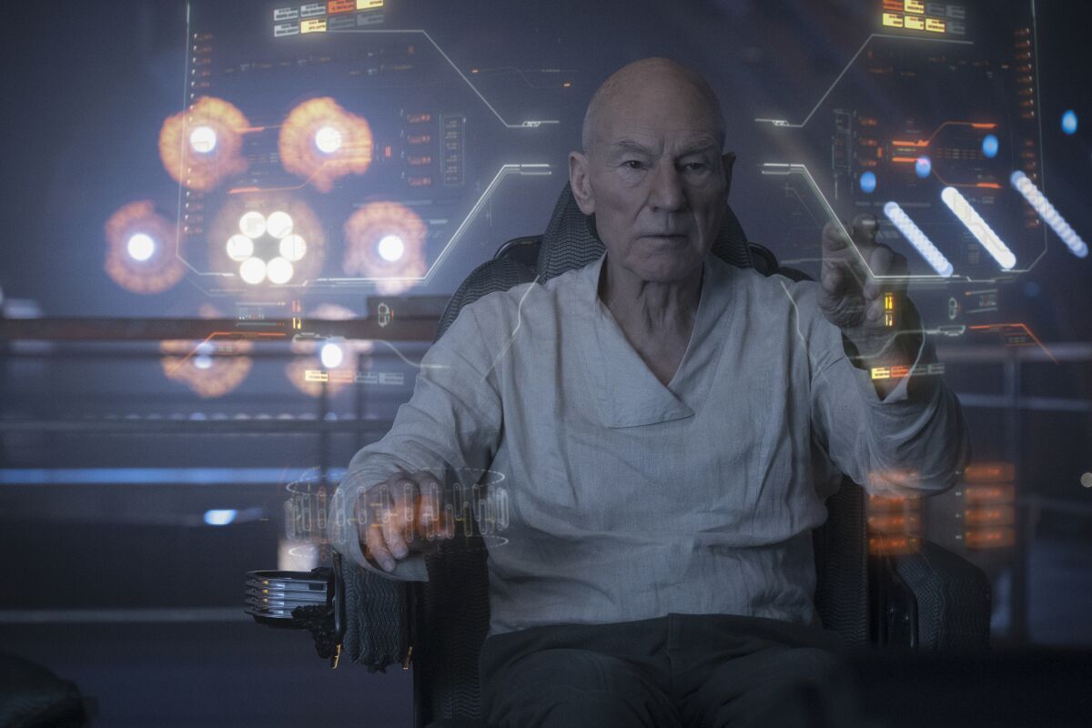 A aging space captain works on a hologram screen